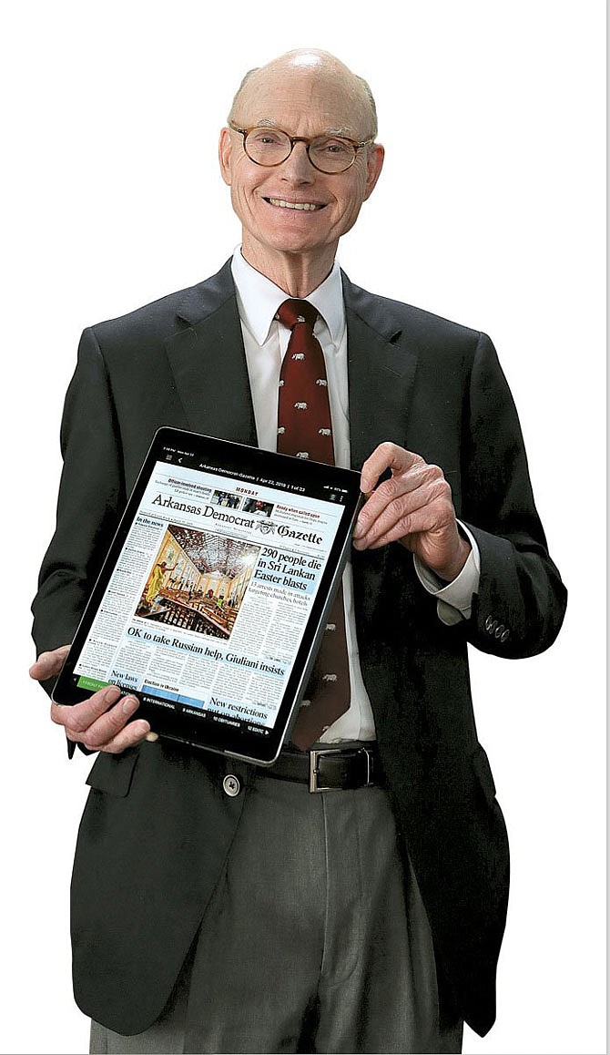 Walter Hussman Jr., president of WEHCO Media, which owns the Fulton Sun, holds an iPad displaying the digital edition of WEHCO flagship paper the Arkansas Democrat-Gazette. WEHCO announced plans to transition the Fulton Sun to a digital-print model, with a seven-day digital edition and a Saturday print edition.