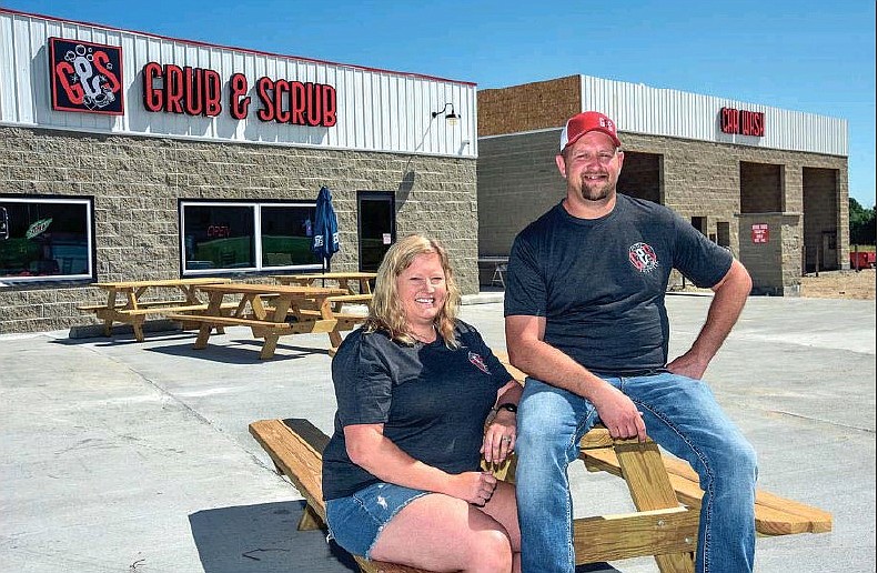 Shawn and Amanda Dworaczyk, owners of the newly-constructed Grub and Scrub in Eugene, pose in front of the business that opened Saturday, June 27, 2020.