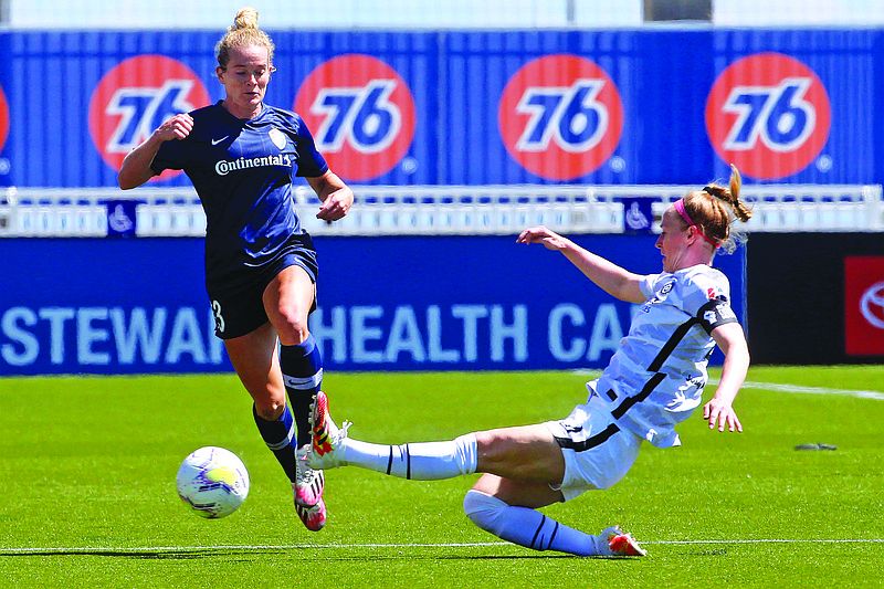 North Carolina Courage forward Kristen Hamilton (23) drives as Portland Thorns FC defender Becky Sauerbrunn (4) slides in with a challenge during the first half of Saturday's NWSL Challenge Cup match at Zions Bank Stadium in Herriman, Utah.