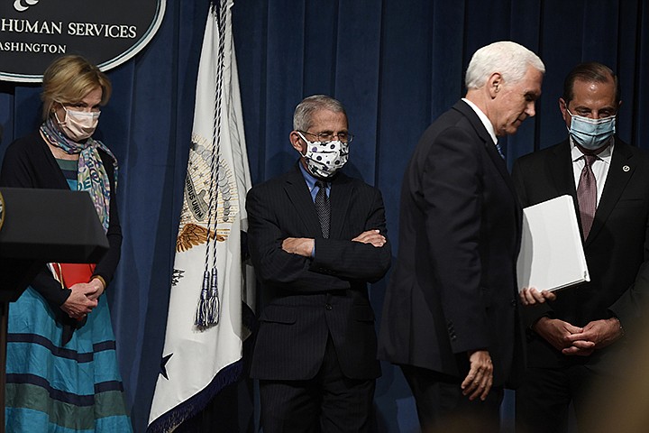 In this June 26, 2020, file photo Vice President Mike Pence, second from right, walks off of the stage following the conclusion of a briefing with the Coronavirus Task Force at the Department of Health and Human Services in Washington. Dr. Deborah Birx, left, Dr. Anthony Fauci, second from left, and Health and Human Services Secretary Alex Azar, right, follow Pence. On Friday, Pence said Americans should look to their state and local leadership for modeling their behavior. (AP Photo/Susan Walsh, File)