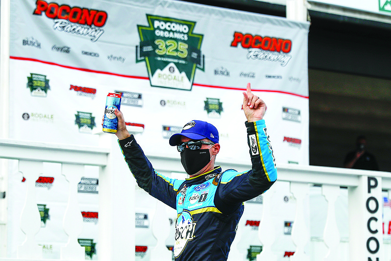 Kevin Harvick celebrates in the victory lane Saturday after winning the NASCAR Cup Series race at Pocono Raceway in Long Pond, Pa.