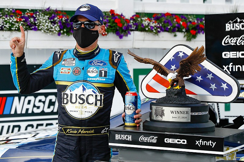 Kevin Harvick celebrates in the winners circle after winning the NASCAR Cup Series auto race at Pocono Raceway, Saturday, June 27, 2020, in Long Pond, Pa. (AP Photo/Matt Slocum)