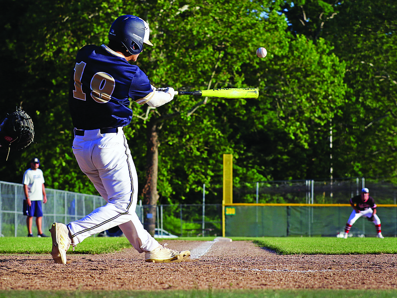 Trevor Austin of Helias makes contact on a pitch during a summer league game against Jefferson City earlier this month at Vivion Field.