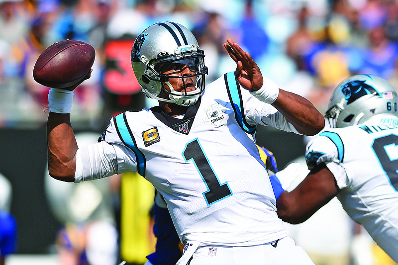 In this Sept. 9, 2019, file photo, Panthers quarterback Cam Newton looks for a receiver during a game against the Rams in Charlotte, N.C. The Patriots have reached an agreement with Newton, a person with knowledge of the deal told the Associated Press.