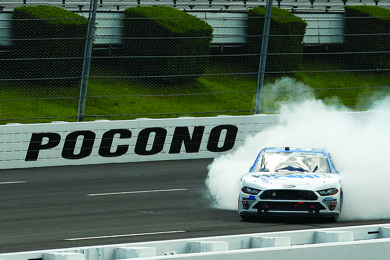 Chase Briscoe smokes his tires in celebration after winning Sunday's NASCAR Xfinity Series race at Pocono Raceway in Long Pond, Pa.
