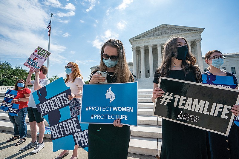 Anti-abortion activists wait outside the Supreme Court for a decision Monday in Washington on the Louisiana case, Russo v. June Medical Services LLC. 