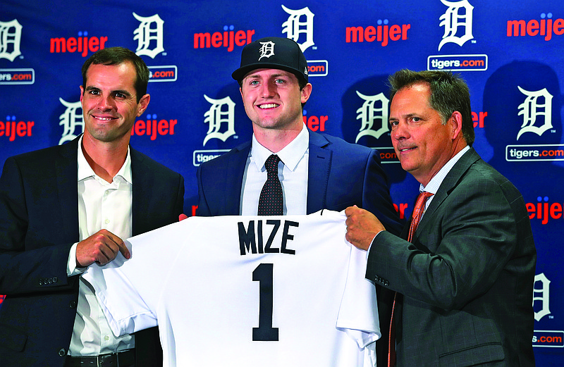 In this June 25, 2018, file photo, Tigers No. 1 overall pick Casey Mize (center) stands with Tigers scout Justin Henry (left) and Scott Pleis, director of amateur scouting, during a news conference in Detroit.