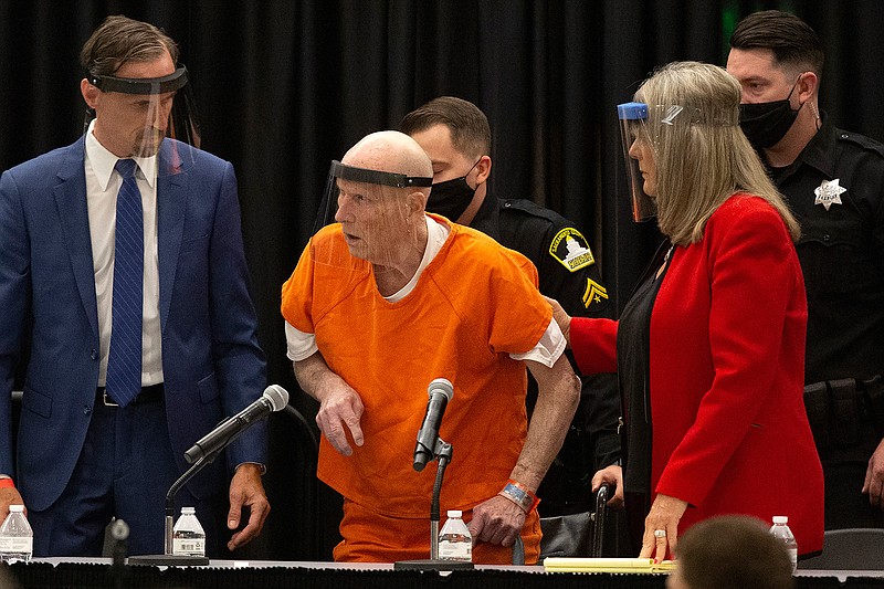 Joseph James DeAngelo Jr., center, charged with being the Golden State Killer, is helped up by his attorney, Diane Howard, on Monday as Sacramento Superior Court Judge Michael Bowman enters the courtroom in Sacramento, Calif. DeAngelo pleaded guilty to multiple counts of murder and other charges 40 years after a sadistic series of assaults and slayings in California. 