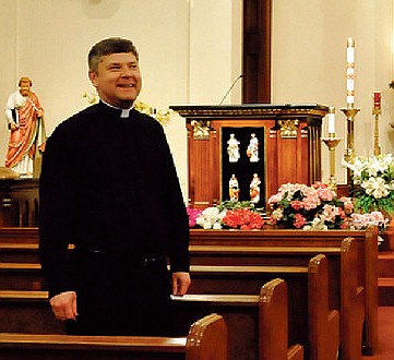 In this April 2011 News Tribune file photo, the Rev. Mark Porterfield is shown standing between pews at St. Thomas the Apostle Catholic Church in St. Thomas, Mo. Porterfield resigned his position as pastor at St. Martin Catholic Church in St. Martins on June 30, 2020, after the Diocese of Jefferson City determined that allegations of misconduct against him involving a former church employee were "credible" but could not be corroborated.