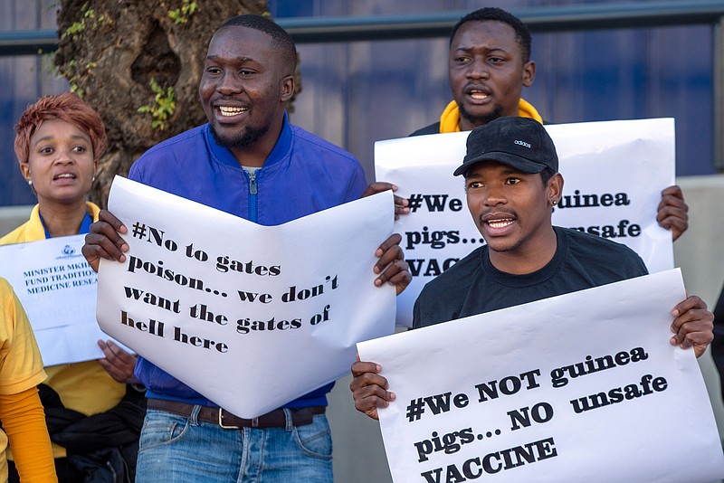 People protest against Coronavirus trials in Africa, outside the University of the Witwatersrand in Johannesburg, South Africa, Wednesday, July 1, 2020.  A protest against Africa's first COVID-19 vaccine trial is underway as experts note a worrying level of resistance and misinformation around testing on the continent.
