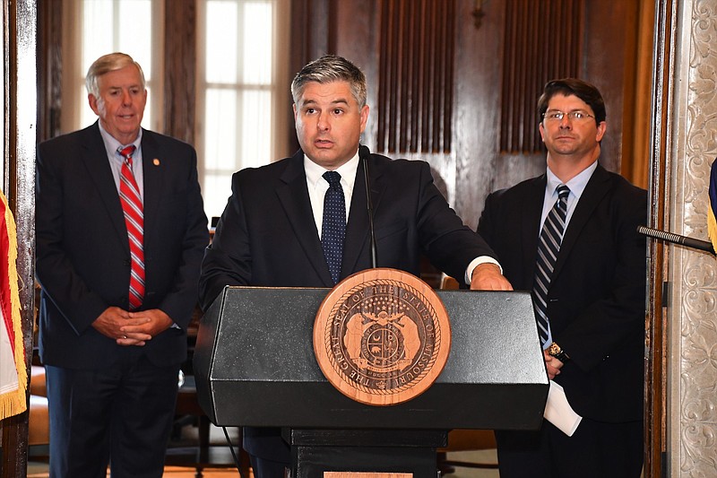 Missouri Department of Economic Development Director Rob Dixon speaks during a COVID-19 briefing Thursday, July 2, 2020, as Gov. Mike Parson, left, and Tim Arbeiter, director of DED's Office of Broadband Development, look on.