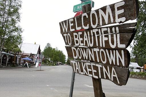 In this June 2, 2020, photo streets in downtown Talkeetna, Alaska are nearly empty. Normally a bustling tourist town, things this summer are pretty quiet in Talkeetna after most major cruise ship companies have canceled their summer tourist seasons because of the coronavirus pandemic. As a result nearly half of Alaska's annual 2.2 million visitors won't be visiting the nation's northernmost state. (AP Photo/Mark Thiessen)