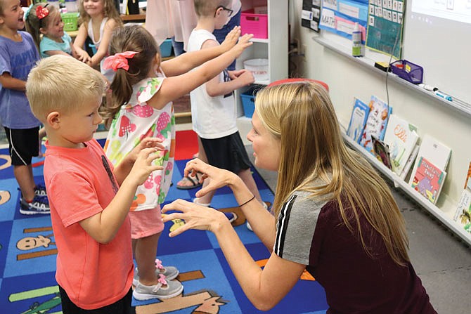 Paraprofessional Alyssa Seidel dances July 1, 2020, to the animal hokey pokey with Blair Oaks kindergartener Brees Bishop.