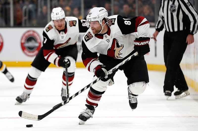 In this Feb. 8, 2020, file photo, Arizona Coyotes' Phil Kessel (81) moves the puck during the second period of an NHL hockey game against the Boston Bruins, in Boston. Injuries led to a disappointing first season in Arizona for Phil Kessel. Now that he's had time to heal up during the NHL's pause to the season, the high-scoring forward could help the Coyotes make a deep run once the season resumes. (AP Photo/Winslow Townson, File)