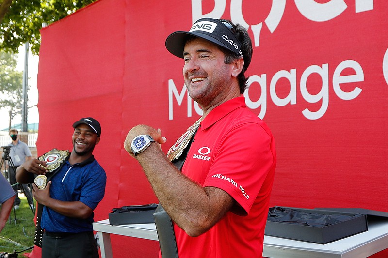 Bubba Watson and Harold Varner III, left, show off the winner's belts after their win in a nine-hole exhibition against Jason Day and Wesley Bryan ahead of the Rocket Mortgage Classic golf tournament, Wednesday, July 1, 2020, at the Detroit Golf Club in Detroit. (AP Photo/Carlos Osorio)