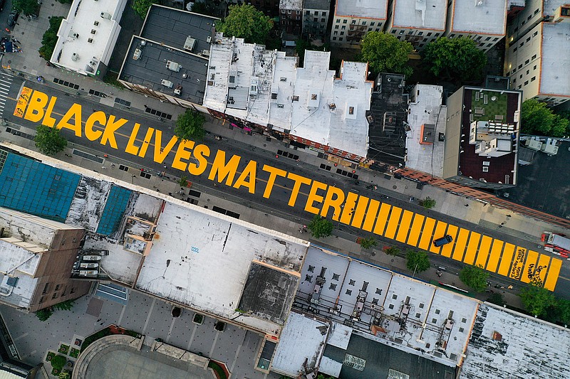 In this  June 15, 2020, file photo, a giant "BLACK LIVES MATTER" sign is painted in orange on Fulton Street, Monday, June 15, 2020, in the Brooklyn borough of New York. Black Lives Matter Global Network Foundation, the group behind the emergence of the Black Lives Matter movement, has established a more than $12 million fund to aid organizations fighting institutional racism in the wake of the George Floyd protests. (AP Photo/John Minchillo, File)