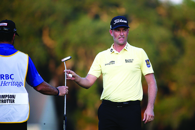 Webb Simpson hands his putter to caddie Paul Tesori after making birdie on the 16th green during last month's final round of the RBC Heritage in Hilton Head Island, S.C.