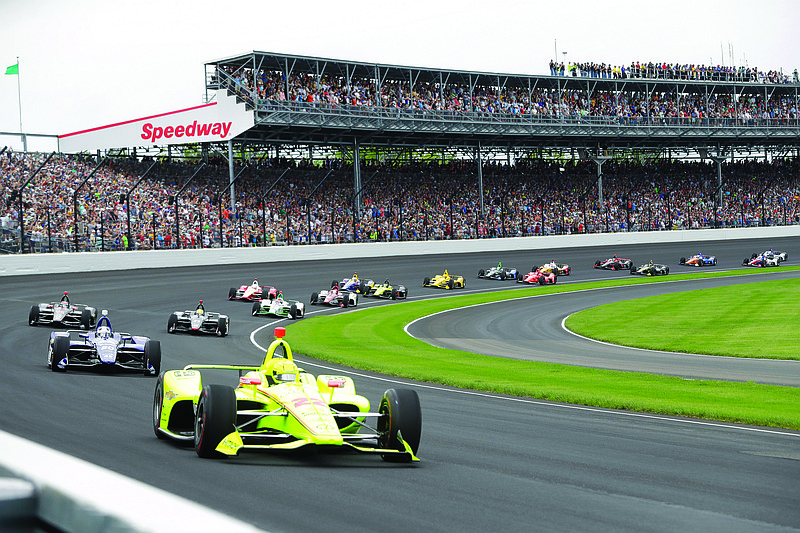 In this May 26, 2019, file photo, Simon Pagenaud leads the field through the first turn on the start of the Indianapolis 500 at Indianapolis Motor Speedway in Indianapolis.