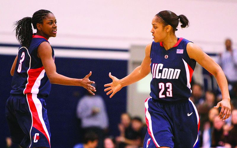 In this Jan. 31, 2009, file photo, Connecticut's Maya Moore (right) is congratulated by Tiffany Hayes after scoring against Georgetown during the second half of a game in Washington, D.C.