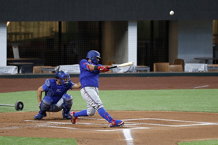 Texas Rangers' Rougned Odor connects for a home run during a baseball practice as catcher Jeff Mathis looks on at Globe Life Field in Arlington, Texas, Friday, July 3, 2020. (AP Photo/Tony Gutierrez)