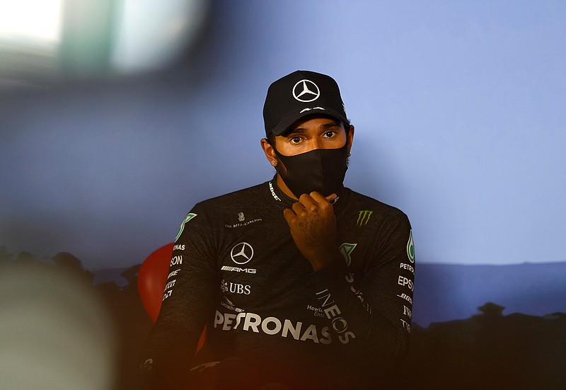 Mercedes driver Lewis Hamilton of Britain, wearing a mask against the spread of the coronavirus, attends a press conference after he clocked the second fastest time during the qualifying session at the Red Bull Ring racetrack in Spielberg, Austria, Saturday, July 4, 2020. The Austrian Formula One Grand Prix will be held on Sunday. (Mario Renzi/Pool via AP)