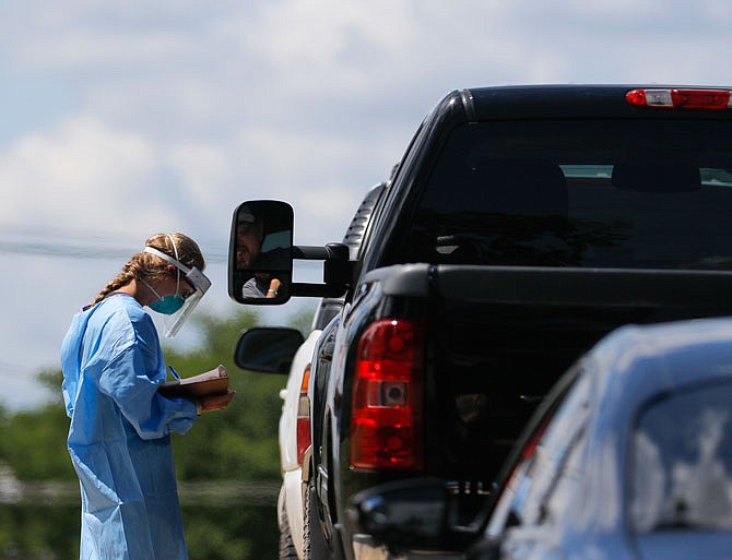 The drive-through coronavirus testing site closes at 2 p.m. on the days it's open, but on Thursday, medical professionals were working to test individuals until at least 3 p.m. as a line of cars formed at the Capital Region Physicians Primary Care Clinic. 