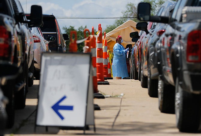 A line of cars forms Thursday, July 2, 2020, at the Capital Region Physicians Primary Care Clinic in Jefferson City for drive-thru coronavirus testing.