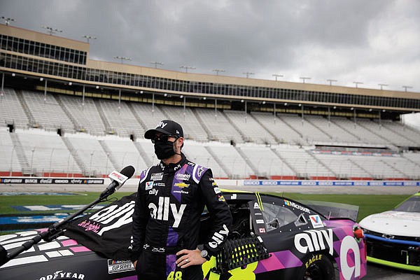 Jimmie Johnson is interviewed before a NASCAR Cup Series race last month in Hampton, Ga.