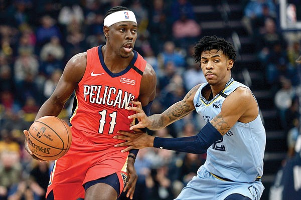 In this Jan. 20 file photo, Pelicans guard Jrue Holiday handles the ball against Grizzlies guard Ja Morant during a game in Memphis, Tenn. Holiday expects basketball to be the easy part of living in the NBA's "bubble" when 22 teams gather in Central Florida to resume their suspended seasons later this month.