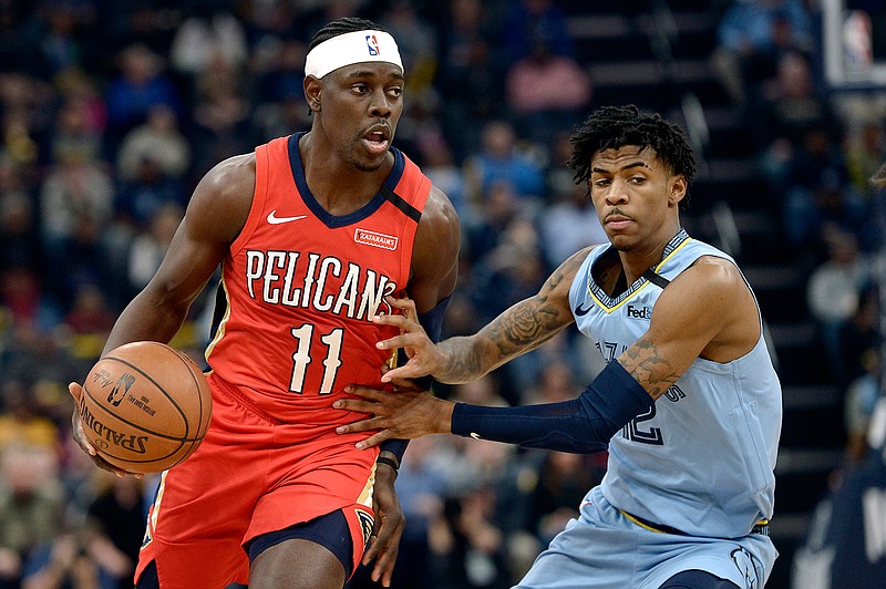  In this Monday, Jan. 20, 2020 file photo, New Orleans Pelicans guard Jrue Holiday (11) handles the ball against Memphis Grizzlies guard Ja Morant in the first half of an NBA basketball game in Memphis, Tenn. The unusual resumption of the NBA season during the coronavirus pandemic is making mental health a priority. Pelicans guard Jrue Holiday expects basketball to be the easy part of living in the NBA's "bubble" when 22 teams gather in Central Florida to resume their suspended seasons later this month. (AP Photo/Brandon Dill, File)