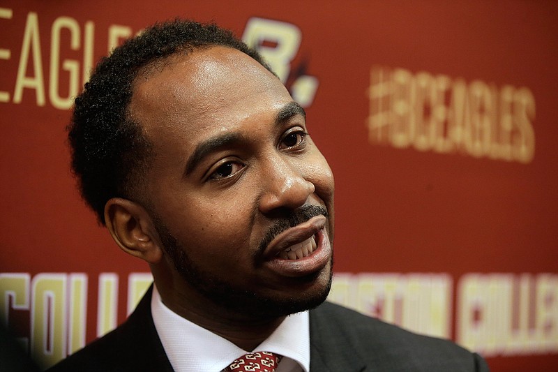 In this April 24, 2017, file photo, Martin Jarmond, newly hired Boston College athletic director, takes questions from members of the media during a news conference on the schools campus, in Boston. Most new athletic directors that take over in July have the luxury of getting acclimated to their new school before things really ramp up in two months. That is not going to be the case for the start of Jarmond's tenure at UCLA. Jarmond began in Westwood on Wednesday, July 1, 2020, after three years at Boston College. (AP Photo/Steven Senne, File)