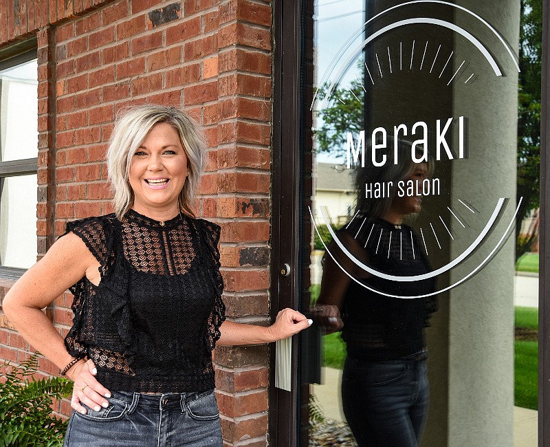 Amber Bunch is seen standing in front of her business, Meraki Hair Salon, located on Hyde Park Road in Jefferson City.