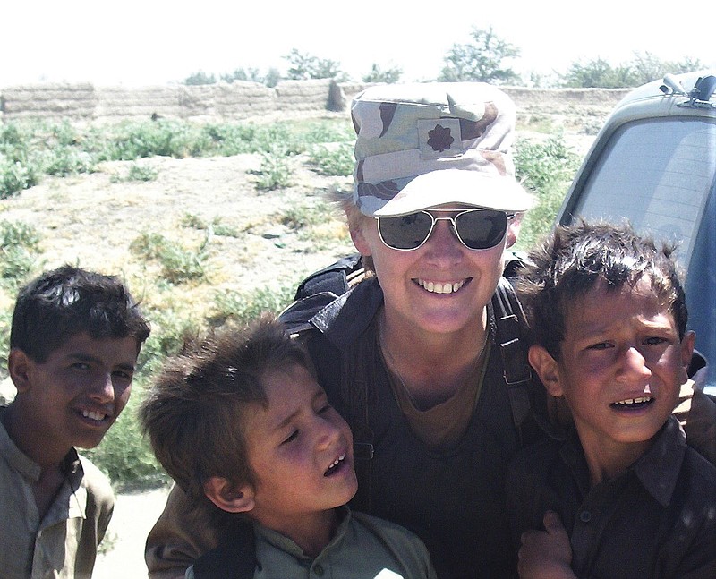 Carol Jean Dameron Bailey, of California, is shown with local children during a deployment to Afghanistan in 2003. Bailey enlisted in the Women's Army Corps of the U.S. Army in 1976. She would later serve in the National Guard and Army Reserve, achieving the rank of lieutenant colonel.