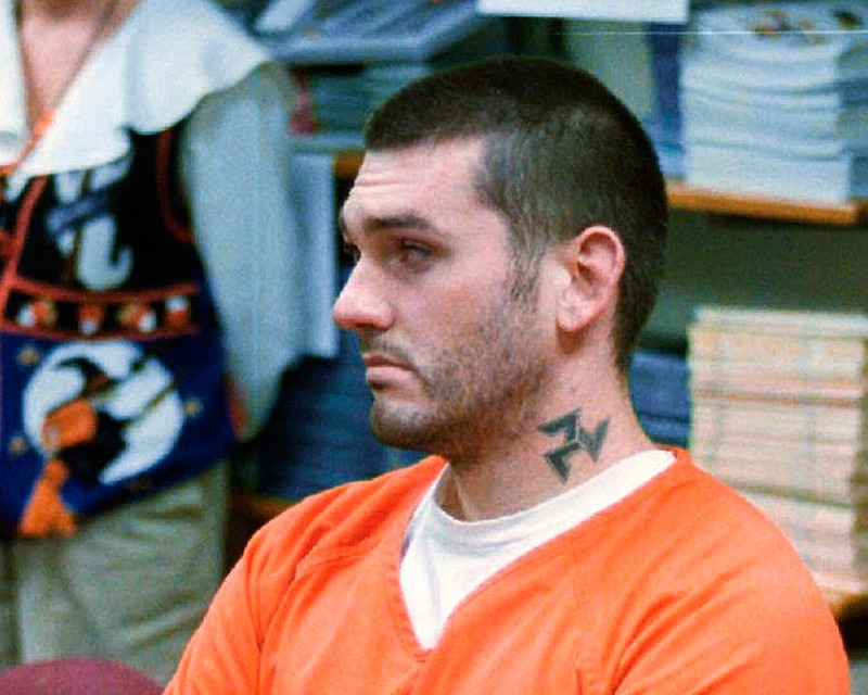 In this Oct. 31 1997, file photo, Daniel Lewis Lee waits for his arraignment hearing for murder in the Pope County Detention Center in Russellville, Ark. On Tuesday, July 7, 2020, family members of the victims of Lee, who is scheduled to be put to death next week, asked a federal judge to delay his execution, saying the coronavirus pandemic puts them at risk if they travel to attend it. (Dan Pierce/The Courier via AP, File)