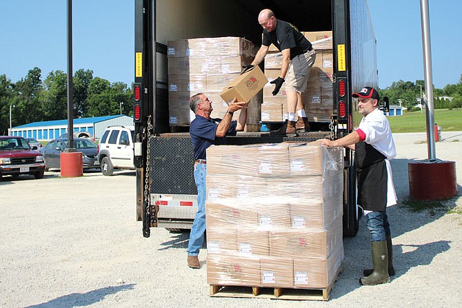 Lt. Gov. Mike Kehoe helps load a truck of donated pork Wednesday at Central Missouri Meat and Sausage.