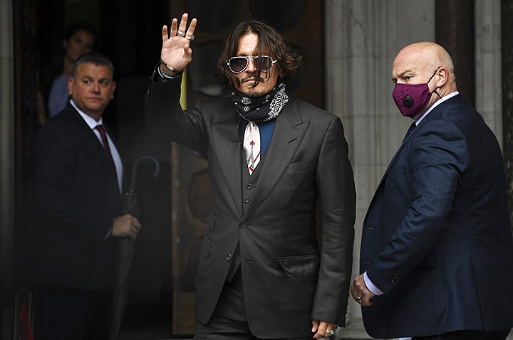 Johnny Depp arrives at the High Court in London, Wednesday July 8, 2020. Johnny Depp is facing a second day of cross-examination by lawyers for British tabloid The Sun, which is defending a libel claim after calling the Hollywood star a "wife beater." Depp is suing The Sun's publisher, News Group Newspapers, and its executive editor, Dan Wootton, over an April 2018 article that said he'd been abusive to ex-wife Amber Heard. (AP Photo/Alberto Pezzali)