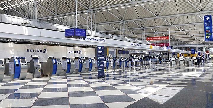 Rows of United Airlines check-in counters at O'Hare International Airport in Chicago are unoccupied on June 25, 2020, amid the coronavirus pandemic. United is sending layoff warnings to 36,000 employees, nearly half its U.S. staff, the airline announced Wednesday, July 8. (AP Photo/Teresa Crawford)
