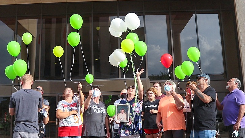 Family and friends release biodegradable balloons in front of Bi-State Justice Building on Thursday, Morgan Angerbauer's birthday. Angerbauer, a diabetic, died in a nursing observation cell at the Bi-State after being denied medical treatment in 2016. The family plans to release balloons each year to honor her memory. (Staff photo by Sara Vaughn)
