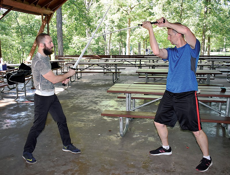 Dillon Dick, left, and Rick Bates, both Jefferson City residents, practice together at the Memorial Park pavilion during Sunday's meeting of the Guild of Knightly Arts.