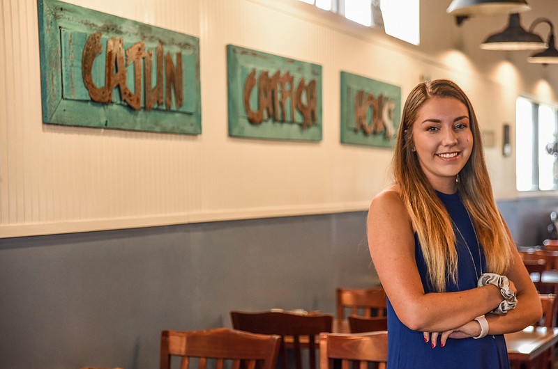 Julie Smith/News TribuneArianna Woods poses inside the new east end Jefferson City location of Cajun Catfish. The former location in St. Martins closed in 2019 so Woods decided to take on the business herself.