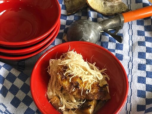 This July 5, 2020 photo shows a grilled banana sundae in Alexandria, VA. The key to grilling bananas is leaving the banana in its protective skin.  (Elizabeth Karmel via AP)