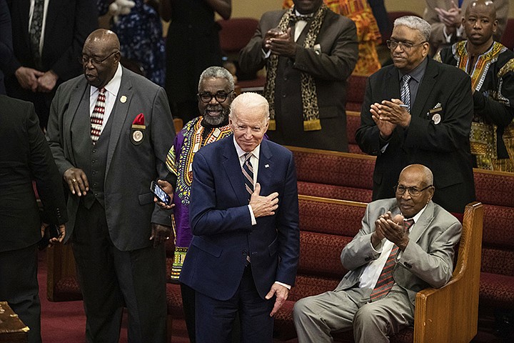In this Sunday, Feb. 23, 2020, file photo, Democratic presidential candidate and former Vice President Joe Biden acknowledges applause from parishioners as he departs after attending services at the Royal Missionary Baptist Church in North Charleston, S.C. Democrats are betting on Biden's evident comfort with faith as a powerful point of contrast in his battle against President Donald Trump. (AP Photo/Matt Rourke, File)