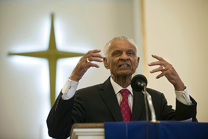 In this  June 19, 2014, file photo, Civil Rights pioneer Rev. C.T. Vivian preaches during a commemoration of the 50th anniversary of the Civil Rights Act in Knoxville, Tenn. The Rev. C.T. Vivian, a civil rights veteran who worked alongside the Rev. Martin Luther King Jr. and served as head of the organization co-founded by the civil rights icon, has died at home in Atlanta of natural causes Friday morning, July 17, 2020, his friend and business partner Don Rivers confirmed to The Associated Press. Vivian was 95. (Paul Efird/Knoxville News Sentinel via AP)