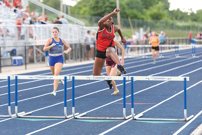 Jefferson City's Rhakala Blackmon gets over the final hurdle of the 300-meter hurdle race Friday in the Russellville Summer Series at Russellville.