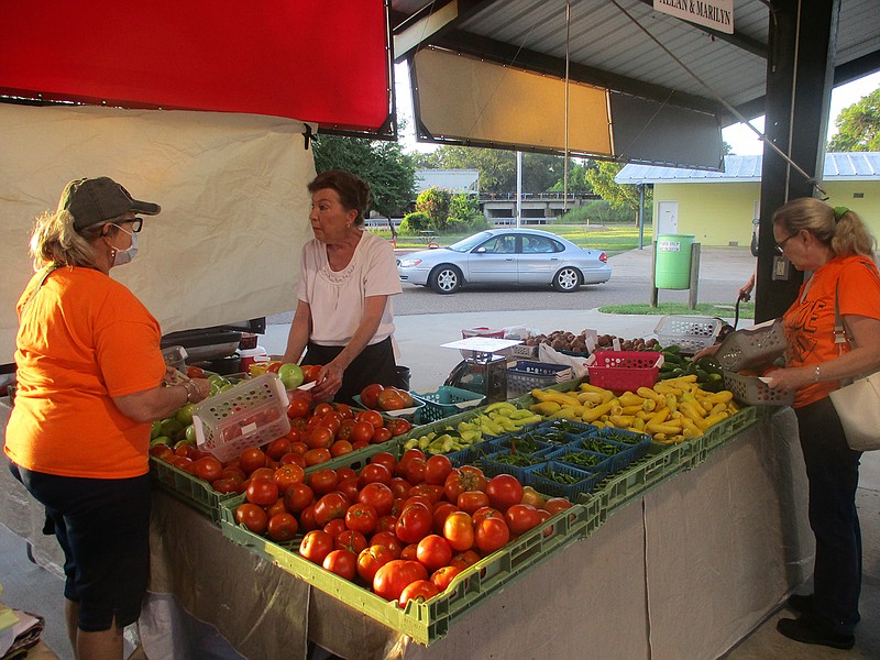 Local fresh produce lovers gather Saturday at the Gateway Farmers Market off of East Ninth Street. The market's weekend visitor count usually ranges from 300 to 500 during Saturday's five-hour opening.