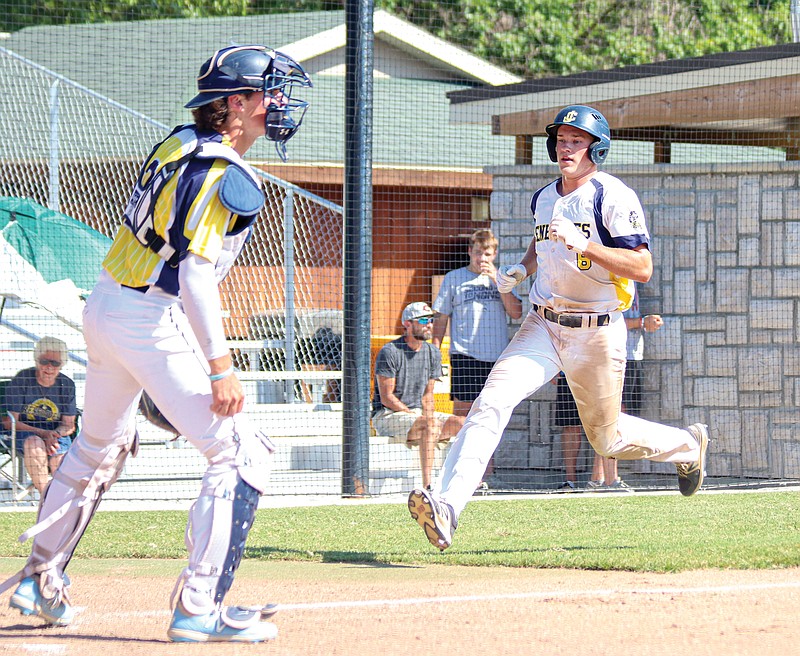 Zach Woehr (right) of the Renegades White team races toward home plate as Renegades Gold team catcher Derek Shikles watches the play unfold during the third inning of Saturday's scrimmage at Vivion Field.