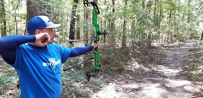 Jason McClain, vice president of Twin City Bow Hunters, takes aim at a target.