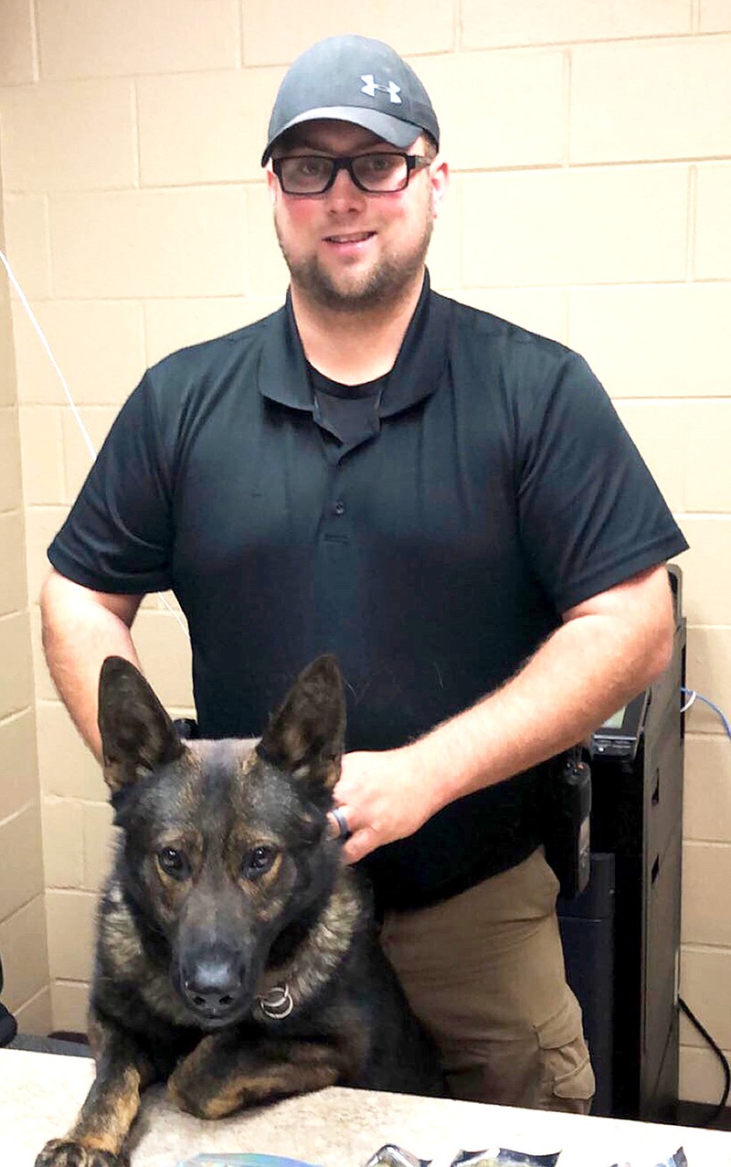 New Boston Police Department Narcotics Officer Westin Fannin stands with his K-9 partner, Bently. Bently is the department's first narcotics dog. Bently has been with the department for about nine months.