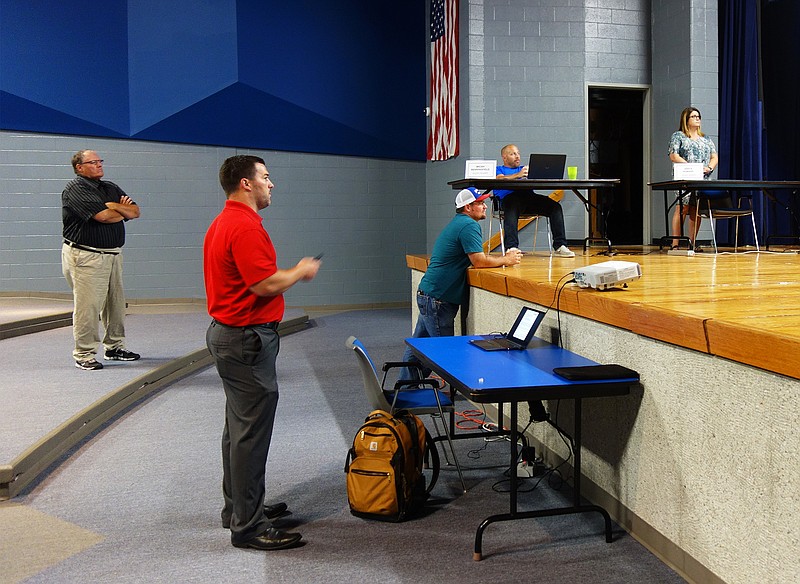<p>Helen Wilbers/FULTON SUN</p><p>Cory Bextermueller (foreground) of Navigate Building Solutions walks the South Callaway Board of Education through a recent roofing project. NBS and South Callaway worked together to cut the price of the project by around 60 percent.</p>