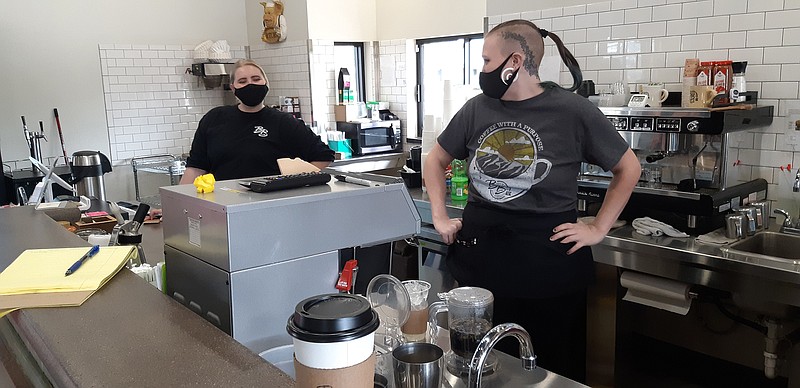 Emma Tye, left, and Chuck Taramona have fun while serving up coffee and tea to their customers Tuesday at Brewsters on the Boulevard in Texarkana, Texas. The coffee shop was closed for about a week to make sure the place was safe after an employee tested positive for COVID-19. Both the workers and their customers were excited and grateful when Brewsters reopened its doors this week.